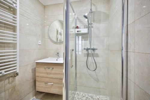 une salle de bain avec douche et lavabo dans l'établissement Le Nid de Montmartre, à Paris