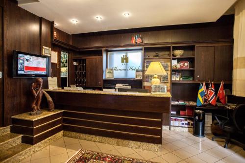 a bar in a restaurant with a monkey statue at Mannu Hotel in Bosa