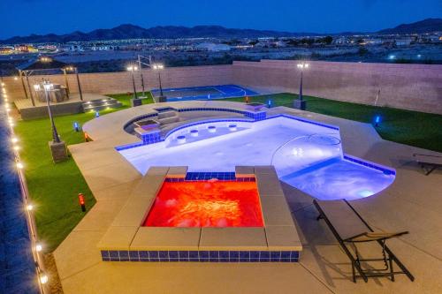 a large swimming pool on top of a building at night at 1900 SqFt House W/25Ft Heated Pool/Spa- Strip View in Henderson