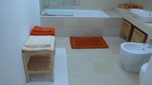 a bathroom with a tub and a sink and a toilet at Villa Resta & Dependance in Castel San Pietro Terme