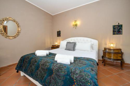 a bedroom with a large bed and a mirror at Prestige Suite Sirmione in Sirmione