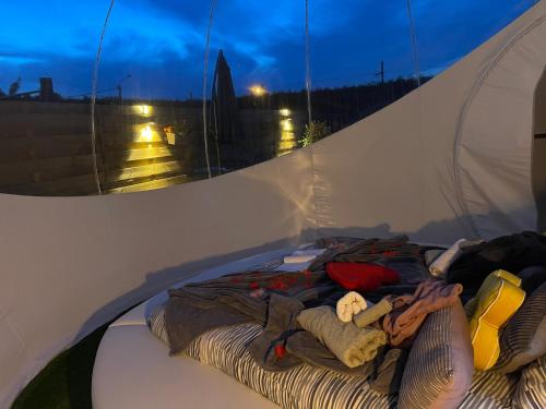 a pile of clothes laying in a tent at Bulle du puits avec jacuzzi et sauna privatif in Havinnes