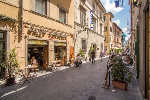 a street in a city with people walking down the street at Hotel Nuova Italia in Florence