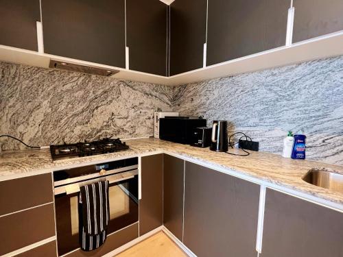 a kitchen with a sink and a counter top at WSP luxury 2b2b apartment in CBD with free parking in Melbourne