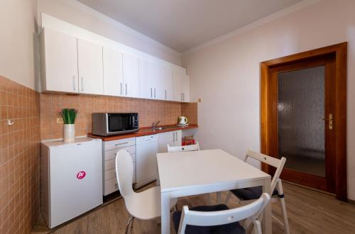 a small kitchen with a table and a microwave at Pension Faber in Český Krumlov