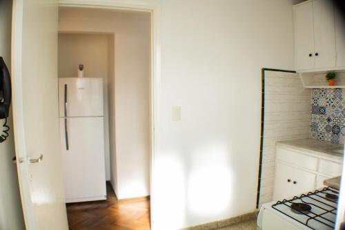 a kitchen with a white refrigerator and a stove at Piazza Mendoza in Mendoza