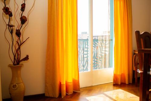 a room with a window with curtains and a vase at Piazza Mendoza in Mendoza