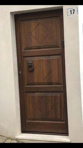 a wooden door with a number on it at le mura in Iglesias