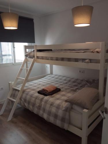 a bedroom with two bunk beds in a room at La Torre Golf Resort, Mero, Torre-Pacheco, Murcia in Murcia