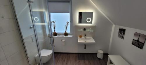 a bathroom with a shower and a sink at Hotel Hoppe in Witten