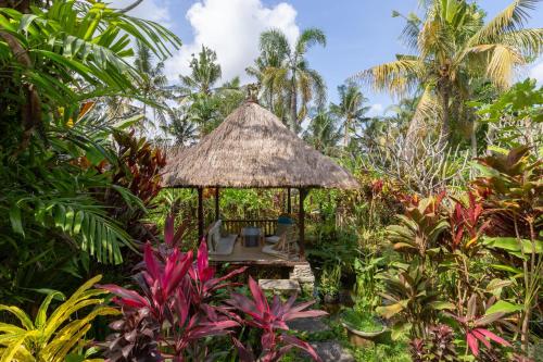 a gazebo in the middle of a garden at Bali Firefly BnB in Ubud