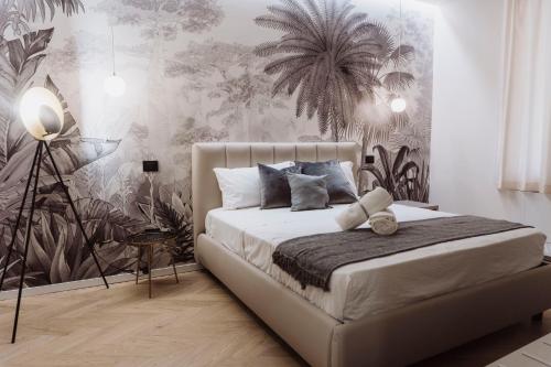 a bedroom with a bed with plants on the wall at Ammare rooms in Agrigento