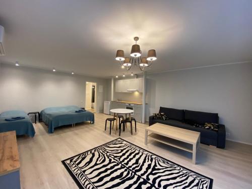 a living room with a couch and a table at Captain's House - Kaptenimaja - Apartments in Kärdla