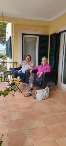 a man and a woman sitting on a couch at Vila De Sol in Sesimbra