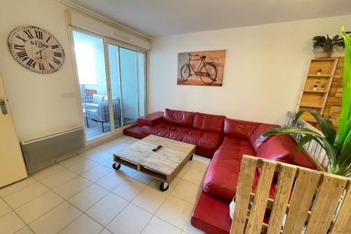 - un salon avec un canapé rouge et un réveil dans l'établissement La Cave Proche gare Centre-Ville  Wifi-Netflix, à Marseille