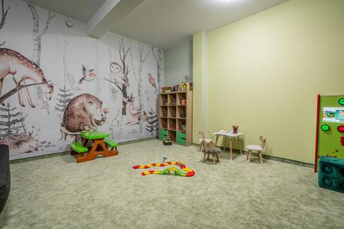 a childs room with a play area with a table and toys at Rezydencja Markowy Dworek in Białka Tatrzanska
