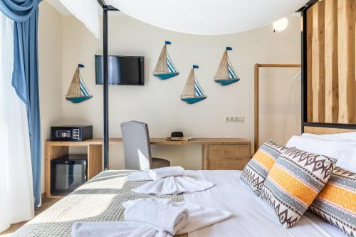 a bedroom with a bed and a desk at AGNONTAS LUXURY VILLAS in Agnontas