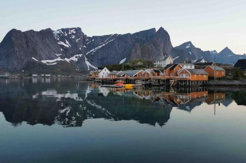 a town on a body of water with a mountain at Reine Front View - Mountain & Seaview in Reine