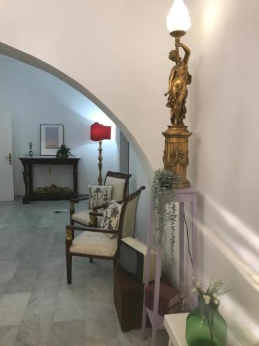 a living room with a chair and a table at L’antica stella in Modica