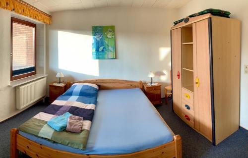 a bedroom with a wooden bed and a dresser at "Ferienhof Alte Mühle" W 2 in Bannesdorf