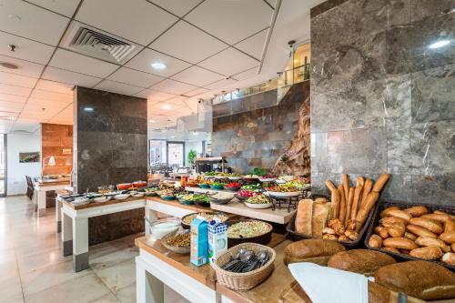 a buffet line with many different types of food at Aviv Holiday Flat in Tiberias