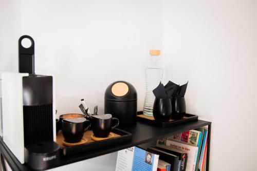 a shelf with cups and other items on it at Au Calme de Hosdent in Braives