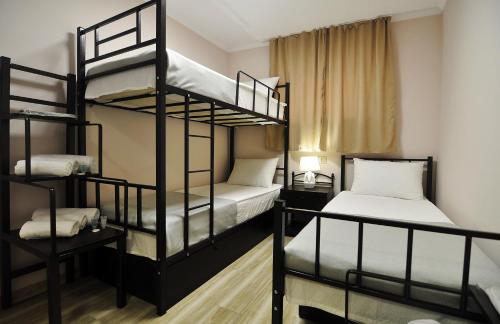a room with two bunk beds and a window at Light Hotel in Tbilisi City