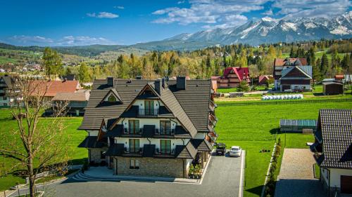 an aerial view of a house with mountains in the background at Rezydencja Markowy Dworek in Białka Tatrzanska