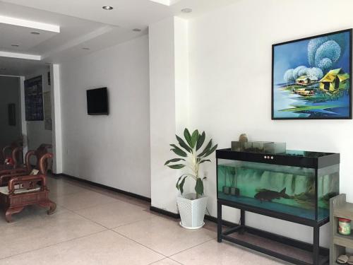 a living room with a fish tank on a wall at Ki Nô Homestay in Hoi An