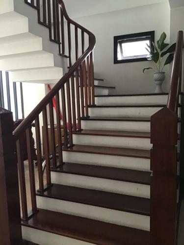 a staircase in a house with black and white stairs at Ki Nô Homestay in Hoi An