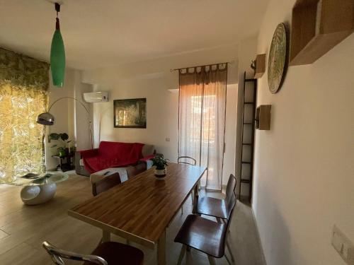 a living room with a wooden table and chairs at Casa Valente in Ladispoli