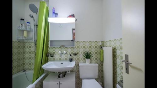 łazienka z umywalką, toaletą i wanną w obiekcie Loft w Zurychu