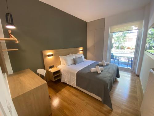 1 dormitorio con cama y ventana grande en Fospitality Greece, en Varkiza