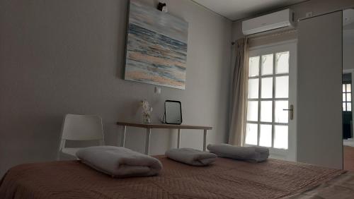 a bedroom with a bed with two pillows on it at Aphrodite goddess in Artemida