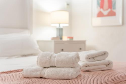 a pile of towels sitting on top of a bed at Numero Uno in Búger