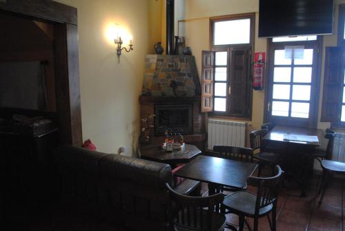 a dining room with a table and a fireplace at Astur Regal in Cadavedo