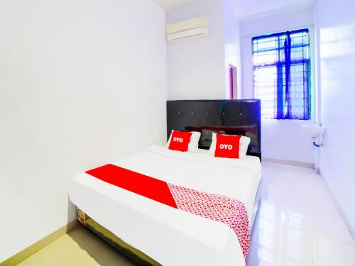 Un ou plusieurs lits dans un hébergement de l'établissement OYO 91283 Sg Premium Guest House
