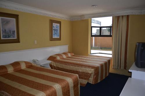 Postelja oz. postelje v sobi nastanitve Hotel San Jeronimo Inn