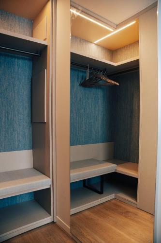a walk in closet with blue walls and wooden floors at Hotel Galassia Suites & Spa in Lido di Jesolo