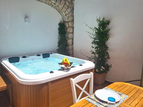 a hot tub in a room with a table at Tiberio House & Spa in Capri