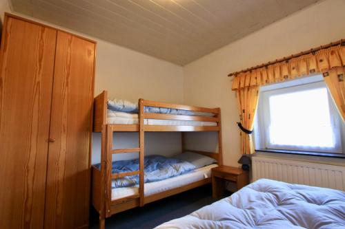 a bedroom with two bunk beds and a window at "Ferienhof Alte Mühle" W 4 in Bannesdorf