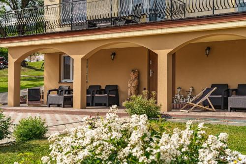 a patio with chairs and a balcony on a house at Pod Horodkiem in Cisna