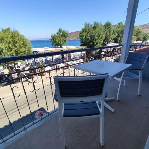 a table and chairs on a balcony with a view of the beach at Hotel Ilion in Petra