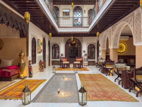 a living room with a large rug on the floor at Perlekech Riad & Spa in Marrakech
