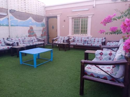 a room filled with couches and a blue table at Al Moltaqua Chalet in Taif