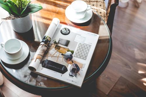 a glass table with a book on top of it at Aviv Holiday Flat in Tiberias