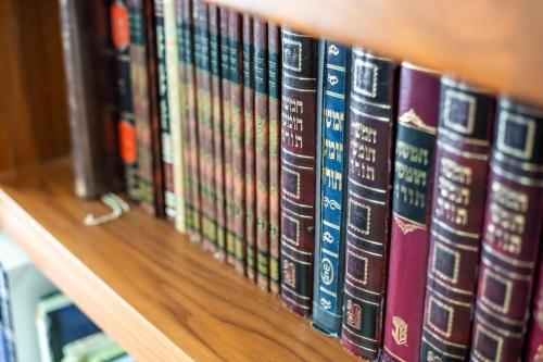 a row of books on a book shelf at Aviv Holiday Flat in Tiberias