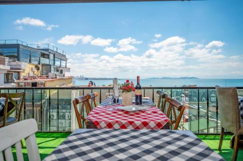 a table on a balcony with a view of the ocean at Valdivia Hotel Sultanahmet in Istanbul