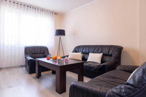 a living room with a couch and a coffee table at Apartmani Gala Foča in Foča