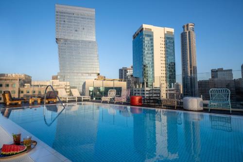 a large swimming pool on the roof of a building at Hotel Indigo Tel Aviv - Diamond District, an IHG Hotel in Tel Aviv